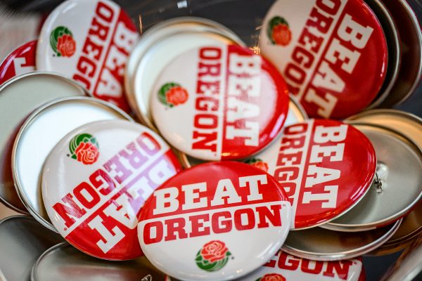 Pins with the words Beat Oregon with a Rose Bowl rose beneath it