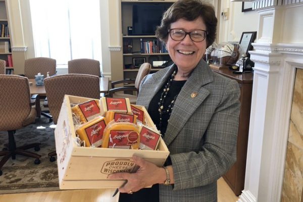 Chancellor Blank holding a box of cheese