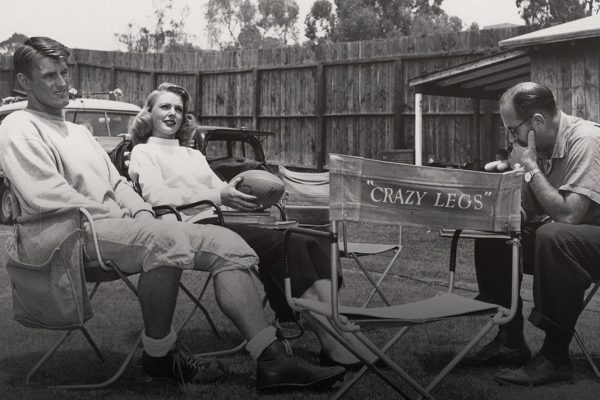 Elroy Hirsch relaxes on the set of the film Crazylegs with costar Joan Vohs and director Francis Lyon.