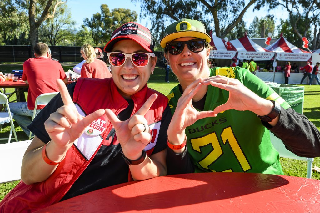 Badger fan Megan Rollo (left) and her wife, an Oregon fan, Jordan Wilde hang out at the Badger Huddle event