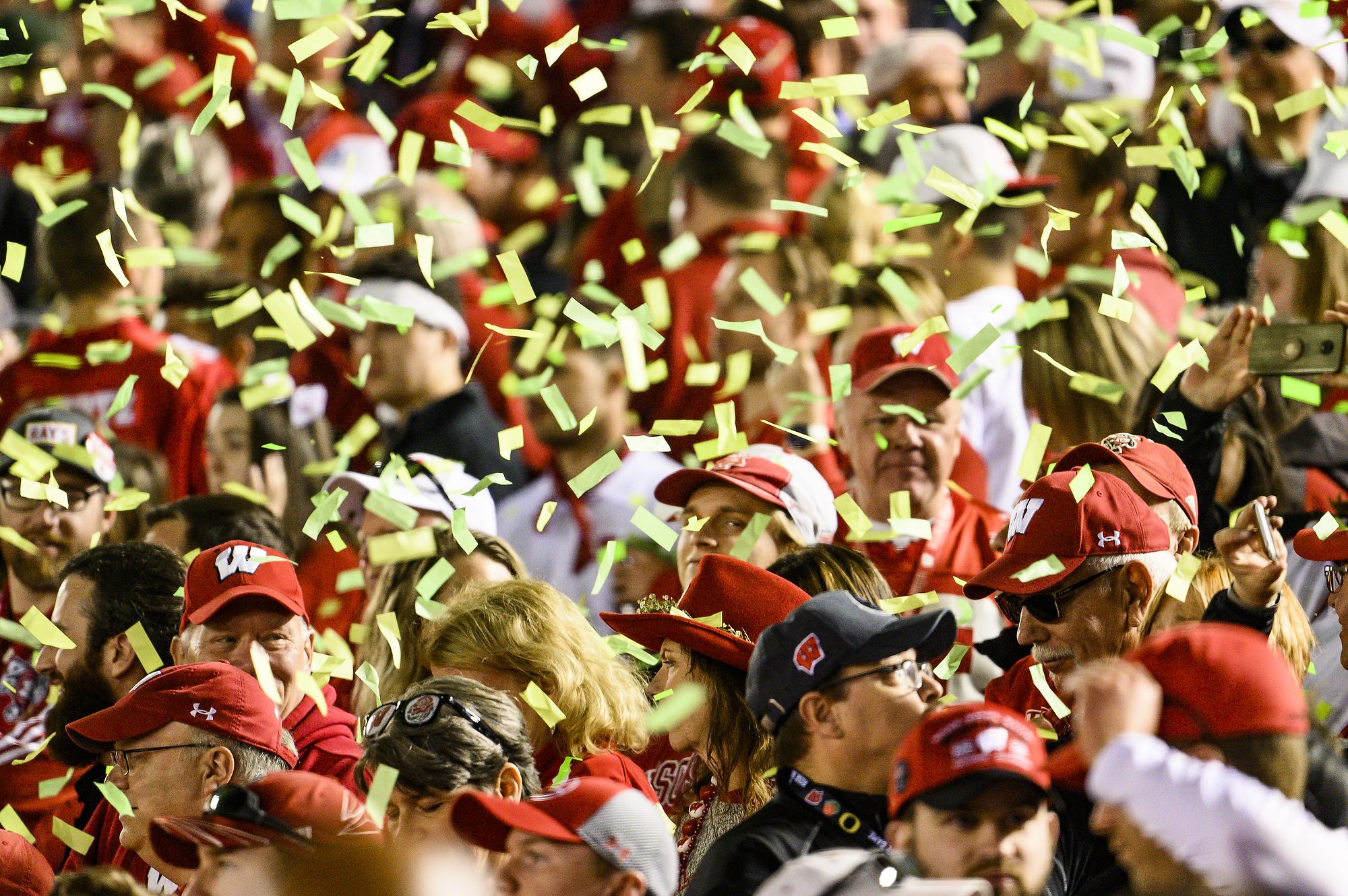 Badger fans are showered with Oregon green confetti following the conclusion of the Rose Bowl Game in Pasadena, California on Jan. 1, 2020.